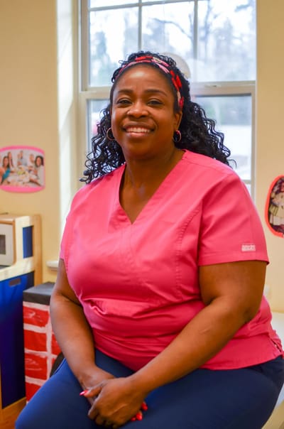 Staff member smiling in a common area.