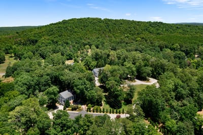 Aerial view of Kingston Wellness Retreat surrounded by trees.