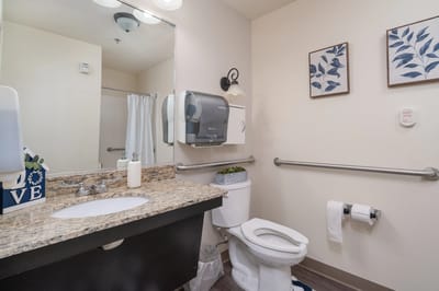 Clean bathroom with accessible features and decor.