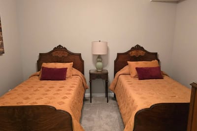 Cozy twin bedroom with decorative bedding.