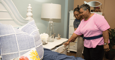 Staff assisting a resident in a private room