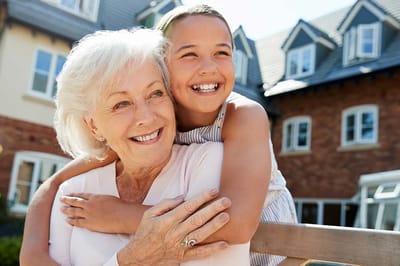 Elderly woman enjoying time with a girl outside