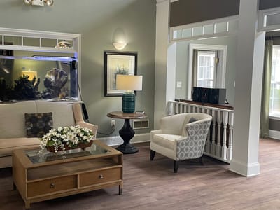 Cozy common area with seating and aquarium.