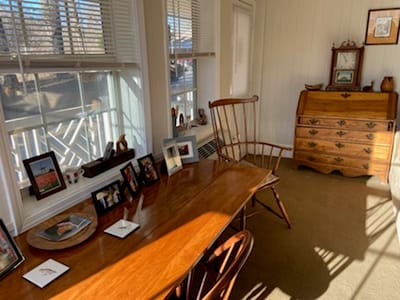 Bright interior with wooden furniture and personal decorations.