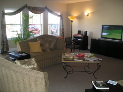 Cozy common area with seating and a television.