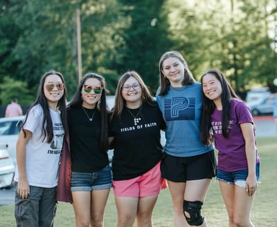 Group of young adults smiling outdoors