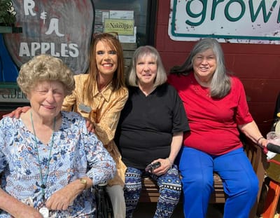 Residents and staff enjoying time together outdoors.