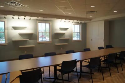 Empty conference room with tables and shelves