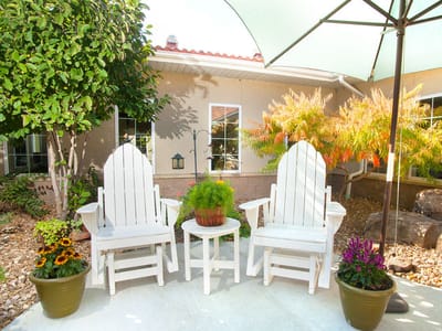 Outdoor seating area with plants and decor.