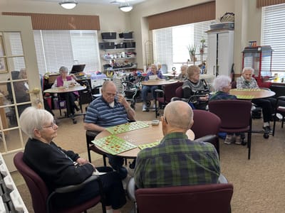 Residents engaged in a game activity indoors.