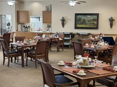 Dining room setup with tables and food service items.
