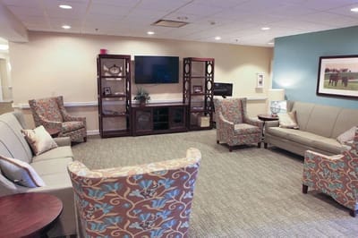 Welcoming common area with seating and television.