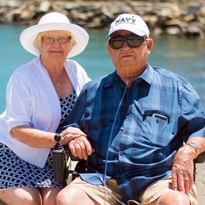 An elderly couple enjoying a sunny day outdoors.