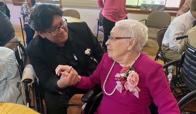 Resident interacts with staff member during an event.
