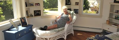 Female resident relaxing in a bright room