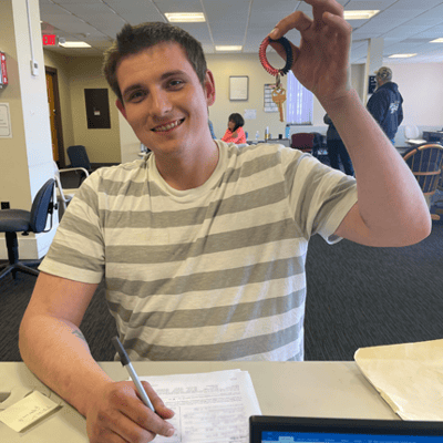 A resident holding a keychain and smiling.