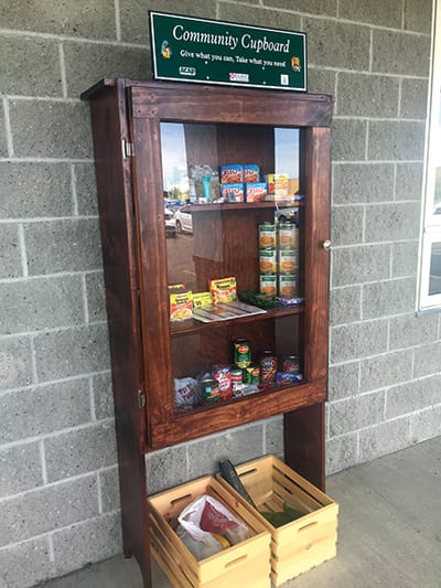 Community cupboard with food items outside.