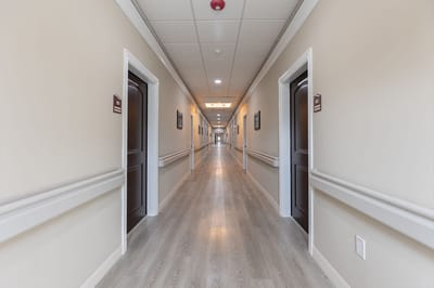 Long hallway with resident rooms and signage