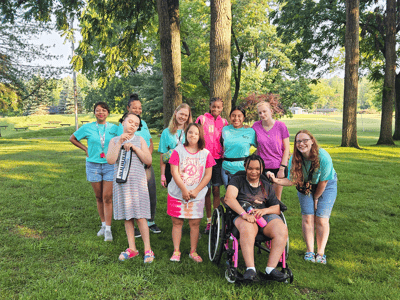 Group of children and young adults enjoying outdoors.
