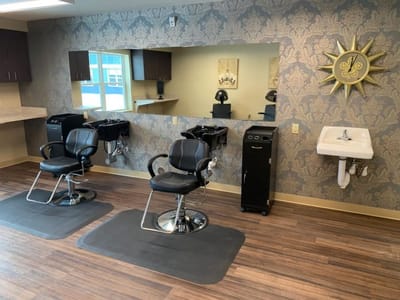 Hair salon area with styling chairs and mirrors
