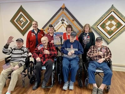Residents and staff celebrating an event indoors.