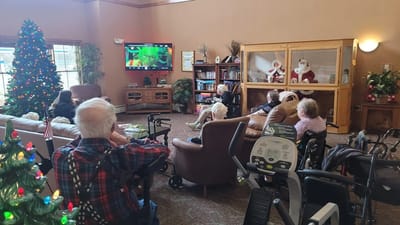 Residents enjoying a festive common area during a holiday event.