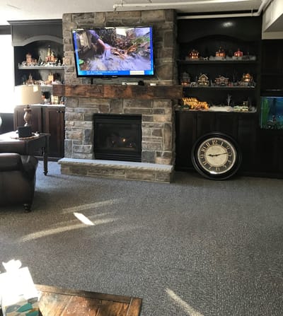 Cozy common area with a stone fireplace and television
