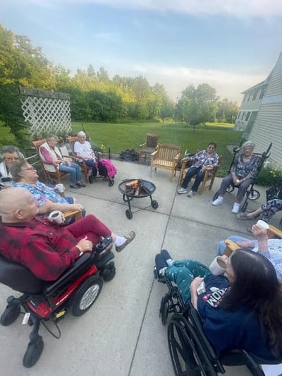 Residents gathered around a fire pit outdoors