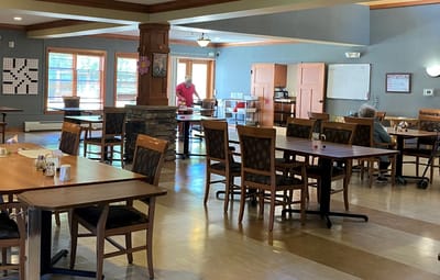 Dining area with residents and staff interacting.