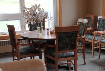 Cozy interior table setup with floral arrangement.