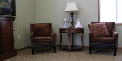 Cozy seating area with decorative lamp and figurines