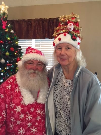 Resident celebrating with Santa Claus