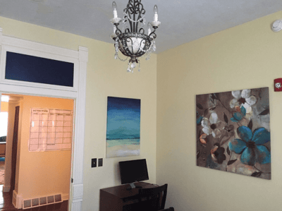 Decorative interior space with paintings and a computer