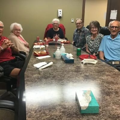 Seniors enjoying a meal together in a dining area.