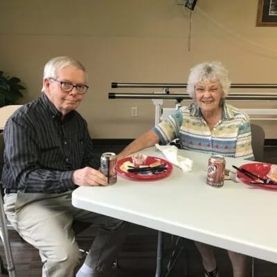 Two residents enjoying a meal at a table.