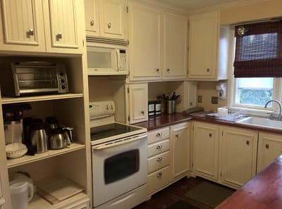 Bright kitchen area with appliances and cabinets