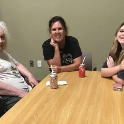 Residents and staff enjoying each other's company at a table.