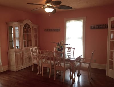 Brightly lit common area with a dining table.