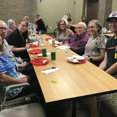 Residents and staff enjoying a meal together.