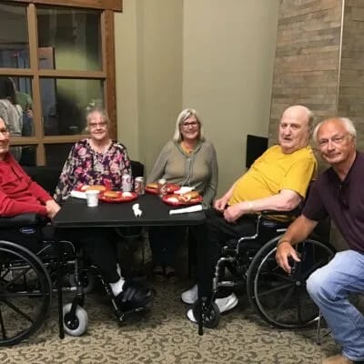 Residents enjoying a meal together in a common area.