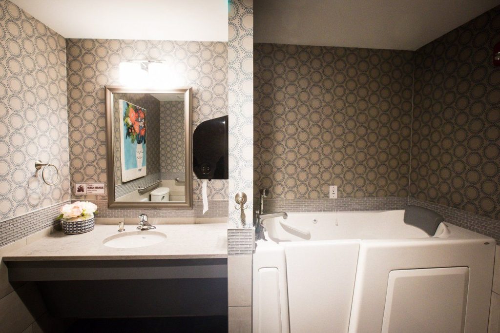 Modern bathroom with a bathtub and sink area.