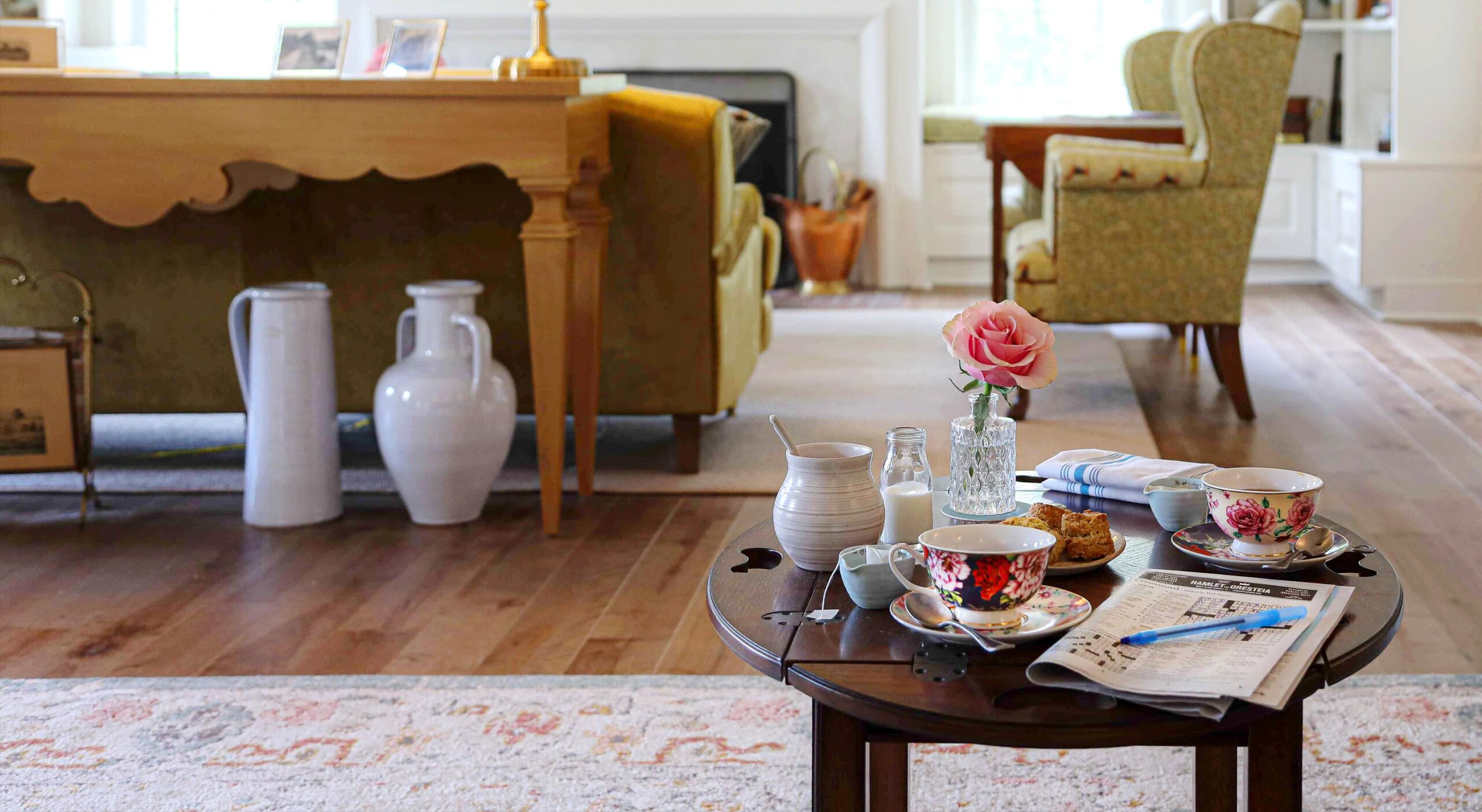 Cozy common area with tea set and rose
