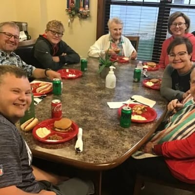 Residents and staff enjoying a meal together
