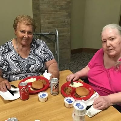 Two women enjoying a meal together in the dining area.