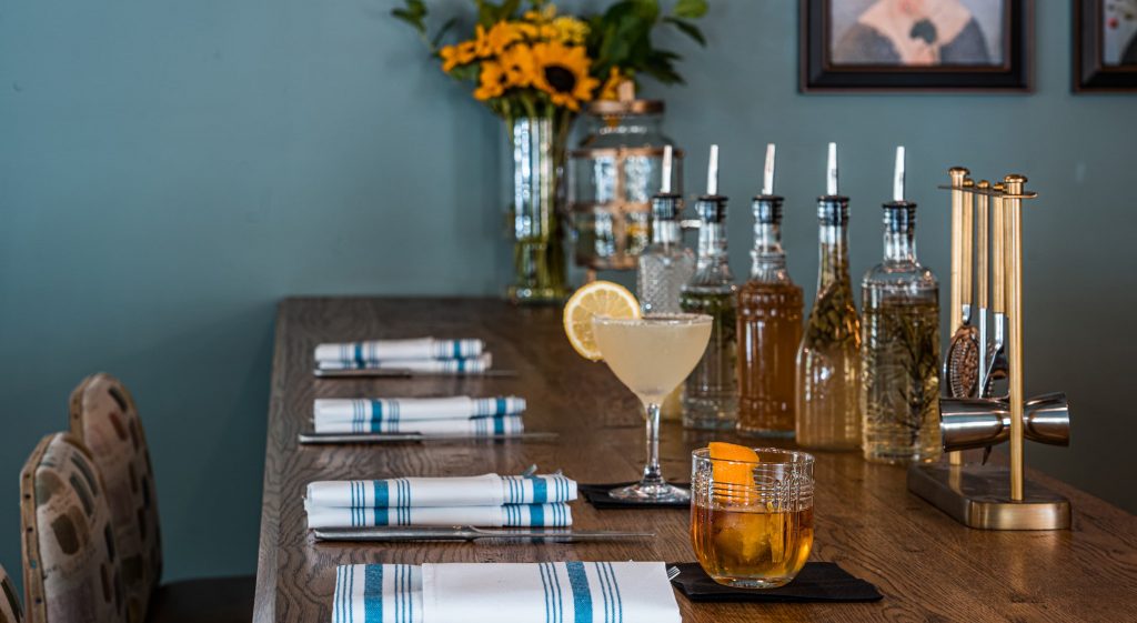 Stylish bar setup with drinks and floral arrangement