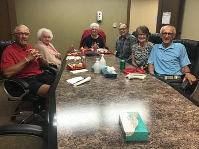Residents enjoying a meal together in a dining area.