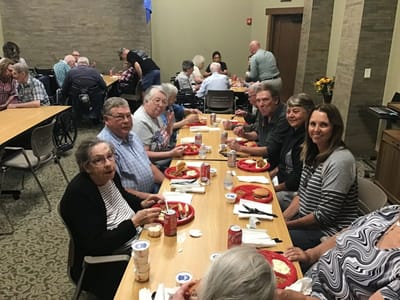 Residents enjoying a meal together in the dining room.