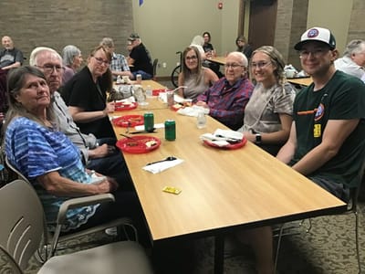 Residents and staff enjoying a meal together