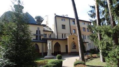 Exterior view of the facility surrounded by trees.