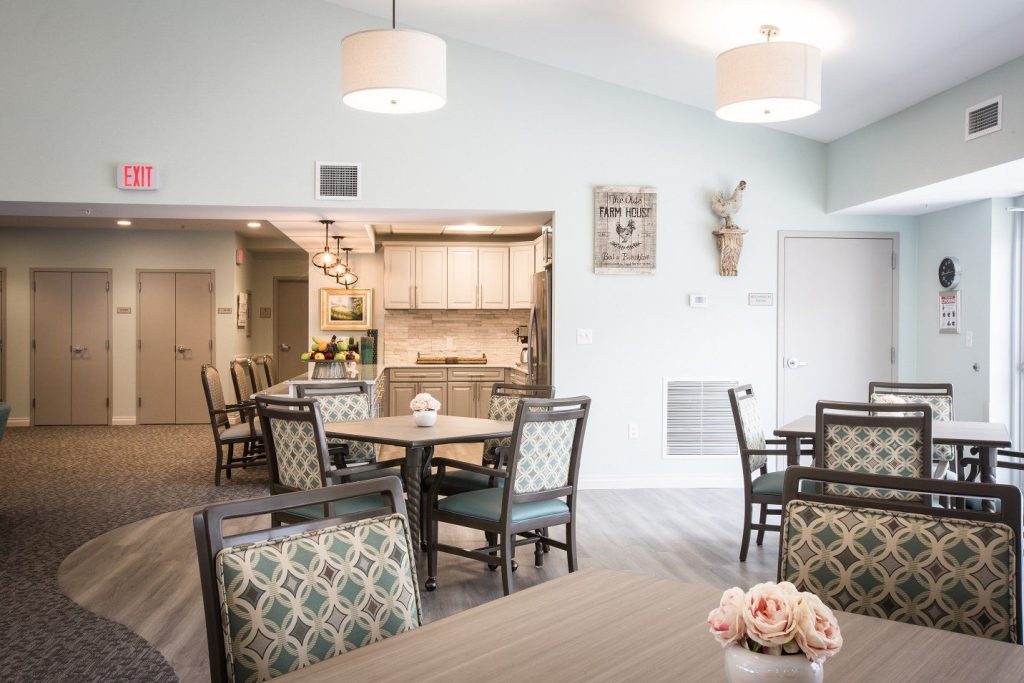 Bright common area with tables and chairs.
